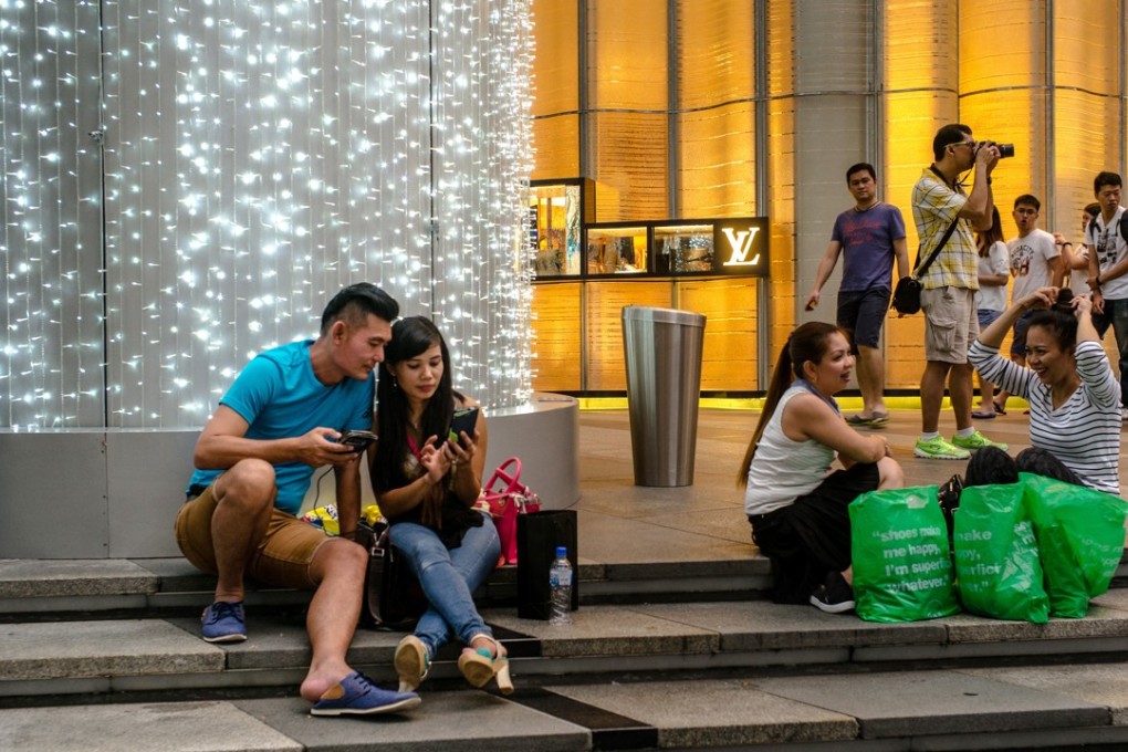 Shoppers on Orchard Road in Singapore. Some experts say the social experience of shopping will help save some brick-and-mortar stores from oblivion in an e-commerce age. Photo: Bloomberg