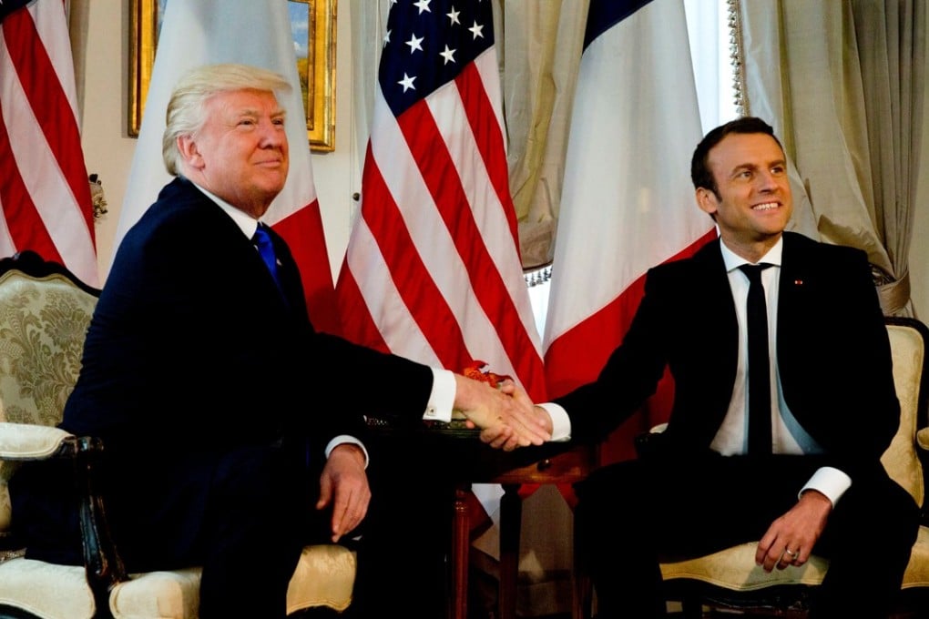 US President Donald Trump appears to ry unsuccessfully to break away from a handshake with French President Emmanuel Macron before a working lunch ahead of a Nato Summit in Brussels, Belgium, on Thursday. Photo: Reuters