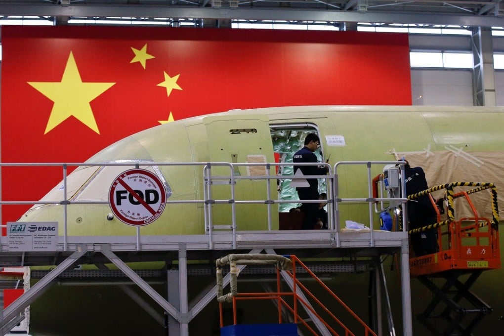 Employees work on China's home-grown C919 passenger jet in Shanghai earlier this month. The plane made its maiden flight on May 5. Photo: Reuters