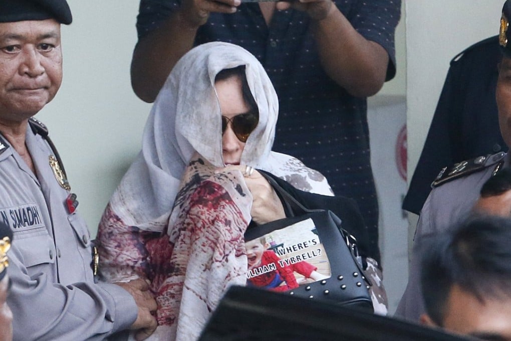 Schapelle Corby is escorted by Bali Police at the parole office in Denpasar. Photo: EPA