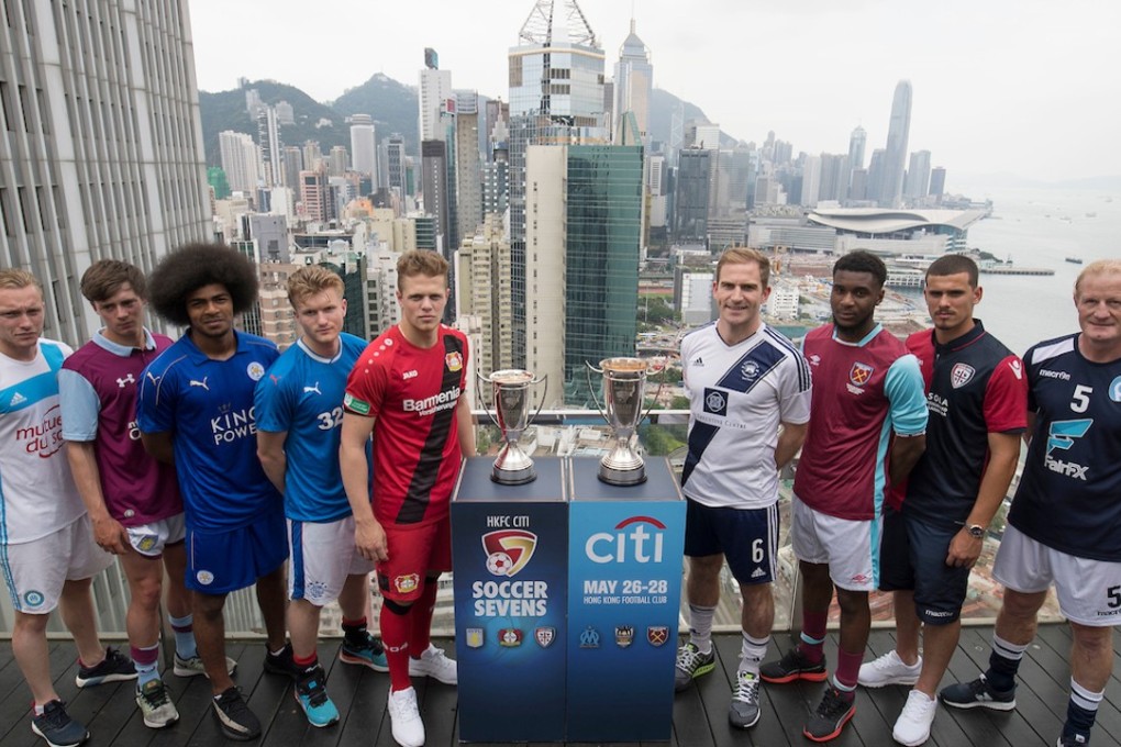 From Left to Right: Olympique Marseille's Lucas Genty, Aston Villa's Harry McKirdy, Leicester City's Hamza Dewan Choudhury, Glasgow Rangers' Max Ambrose, Bayer Leverkusen's Joel Abu Hanna, Causeway Bay's Andrew Wylde, West Ham United's Moses Makasi, Cagliari Calcio's Vasco Oliveira, and playonPROS's Colin Hendry pose for a photograph in front of Hong Kong's urban landscape to celebrate the launch of the HKFC Citi Soccer Sevens 2017 on 25 May 2017 in Causeway Bay, Hong Kong, China. Photo by Chris Wong / Power Sport Images