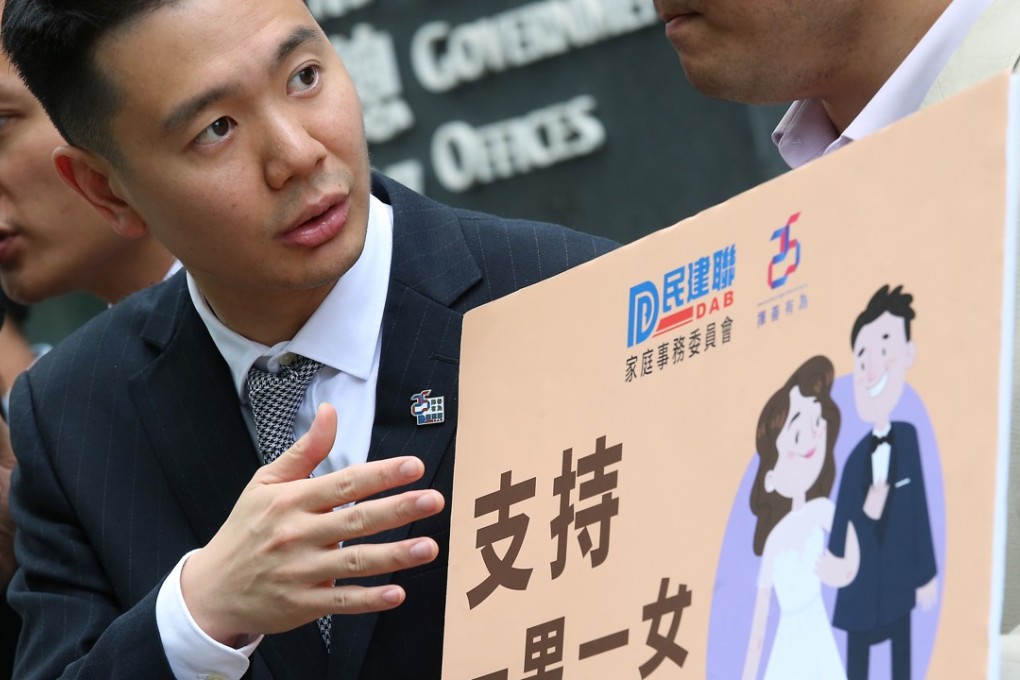Lawmaker Holden Chow Ho-ding (left) and members of DAB petition over "safeguarding family values" in a response to the earlier judicial review from a gay civil servant over his husband benefits outside Central Government offices. Photo: David Wong