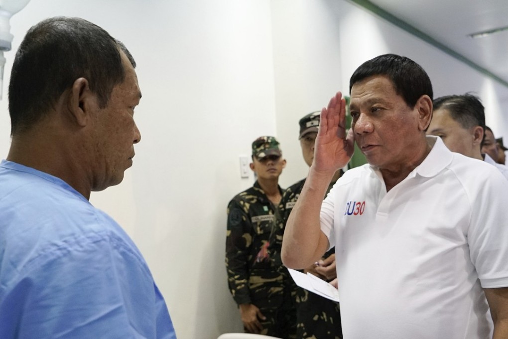 Philippine President Rodrigo Duterte salutes during his visit to wounded combatants following gunbattles in Sulu province, Mindanao. Photo: AP
