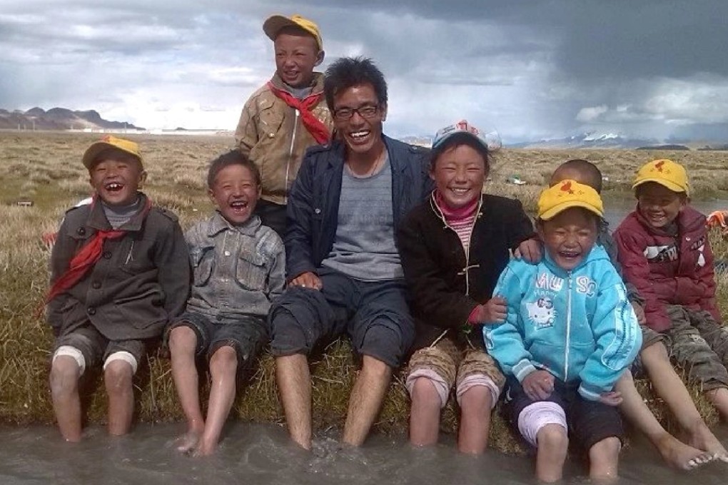Qimei Ciren plays with pupils in a river near the school. Photo: Handout