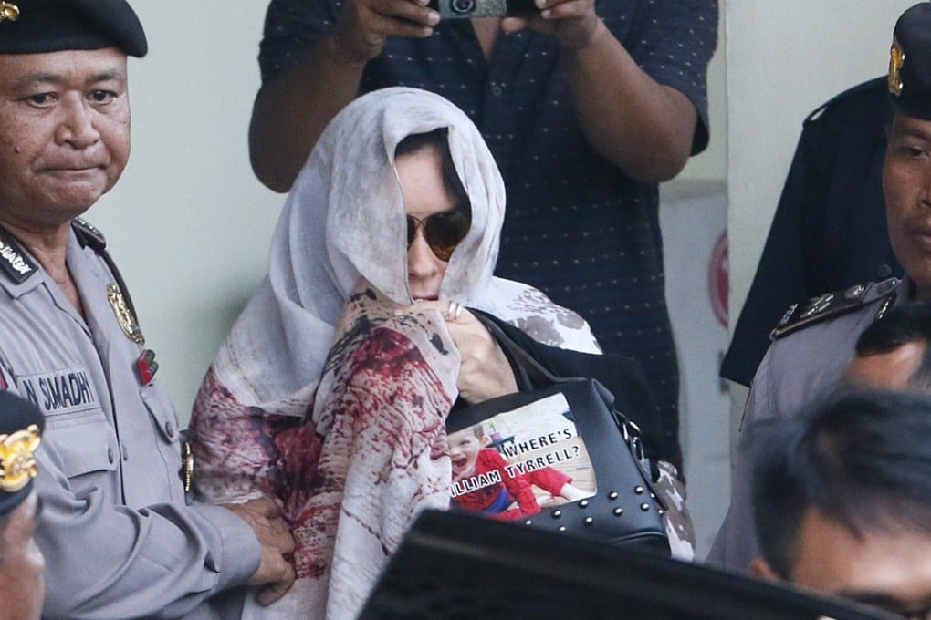 Australian Schapelle Corby is escorted by Bali Police at the parole office in Denpasar. Photo: EPA
