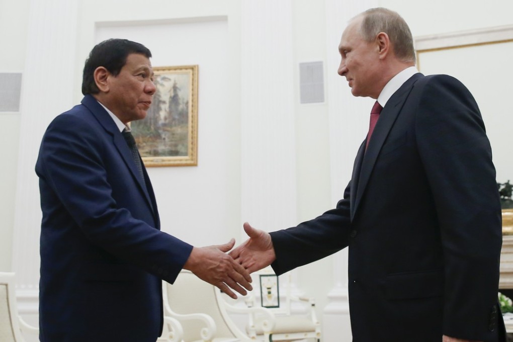 Russian President Vladimir Putin, right, shakes hands with Philippine President Rodrigo Duterte during their meeting in the Kremlin in Moscow, Russia, Tuesday, May 23, 2017. (Maxim Shemetov/Pool Photo via AP)