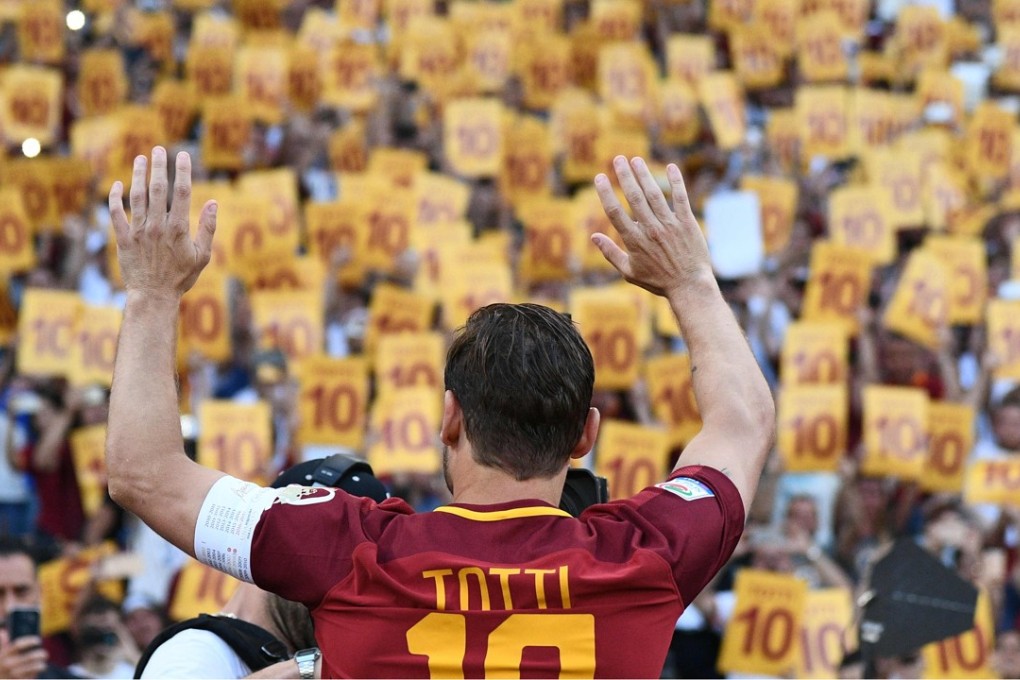 Totti greets fans during a ceremony following his last match with AS Roma. AFP PHOTO / Vincenzo PINTO