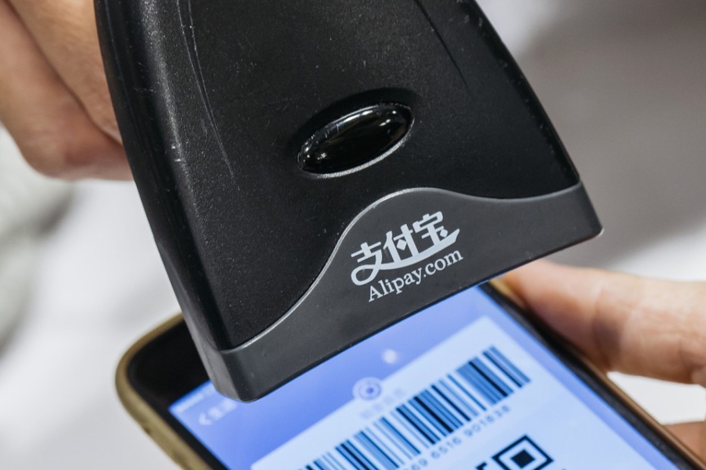 An employee scans a quick response (QR) code displayed on the Alipay. Bloomberg