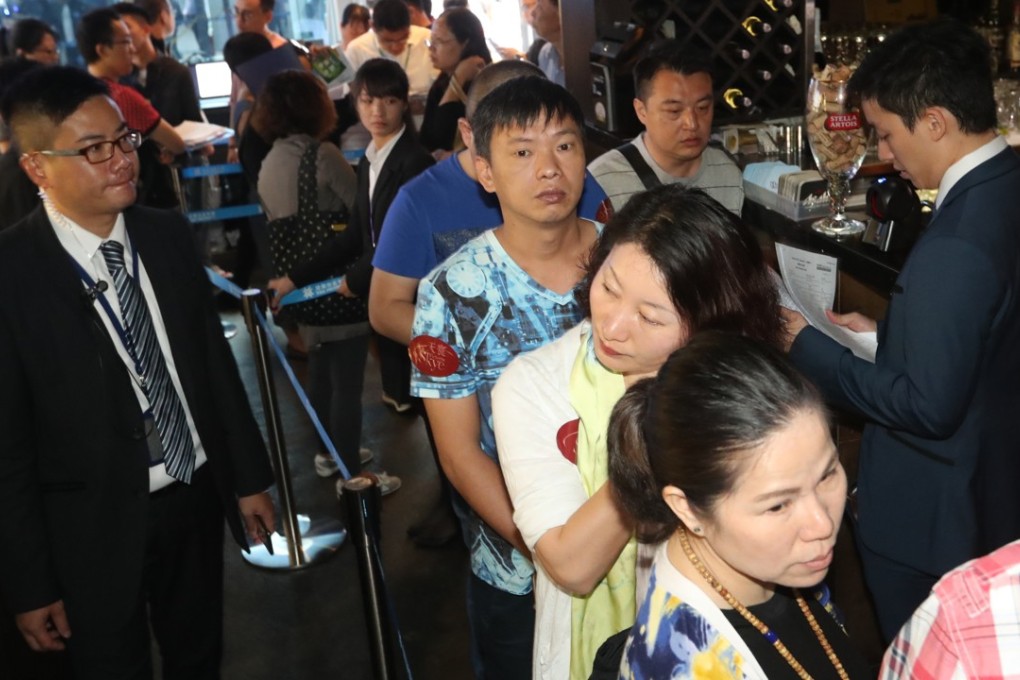 People queue up to buy a property at the old airport site in Kai Tak. Photo: Edward Wong