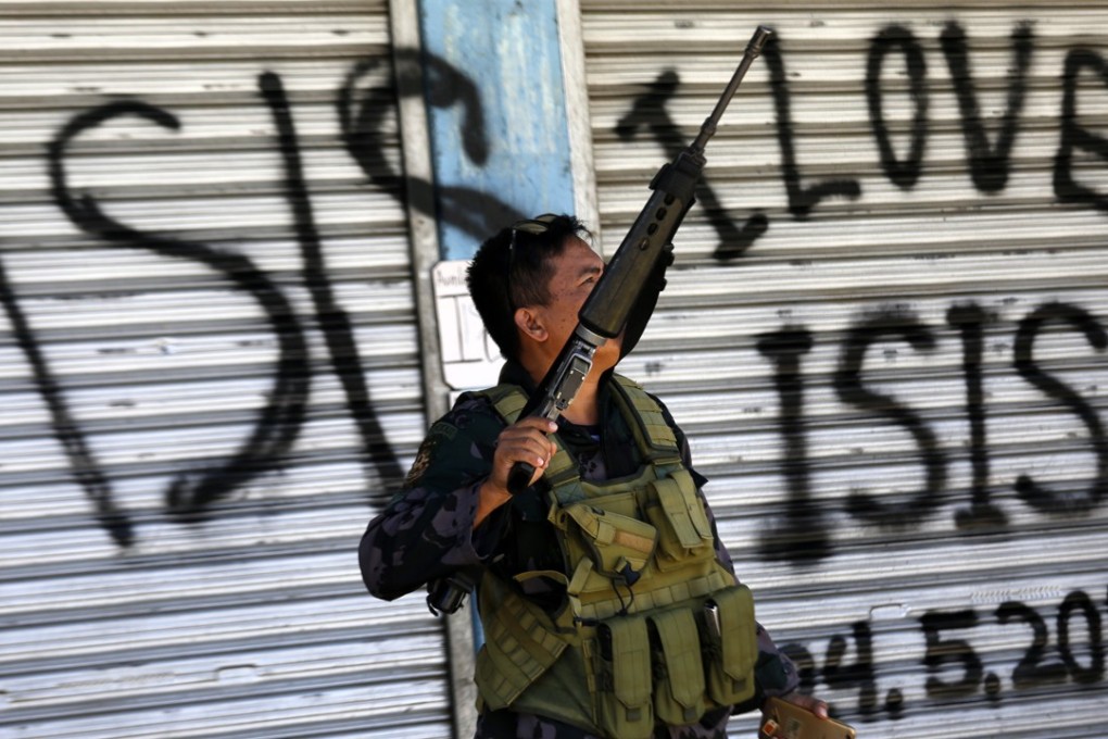 A Filipino government troop on patrol in Marawi City, southern Philippines, where fighting between Islamist militants and government forces continues. Photo: EPA
