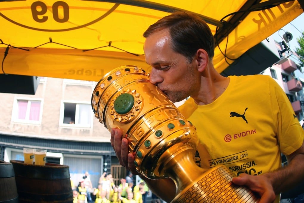 Dortmund coach Thomas Tuchel kisses the trophy at Borsigplatz during celebrations after winning the German Cup. Photo: AFP