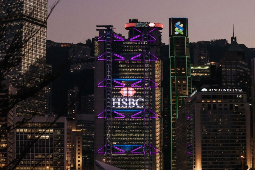 The HSBC and Standard Chartered buildings stand illuminated in Central, the commercial heart of Hong Kong, on February 13. Hong Kong’s financial services firms must step up self-policing if the city is to continue to grow and compete with other jurisdictions. Photo: Bloomberg
