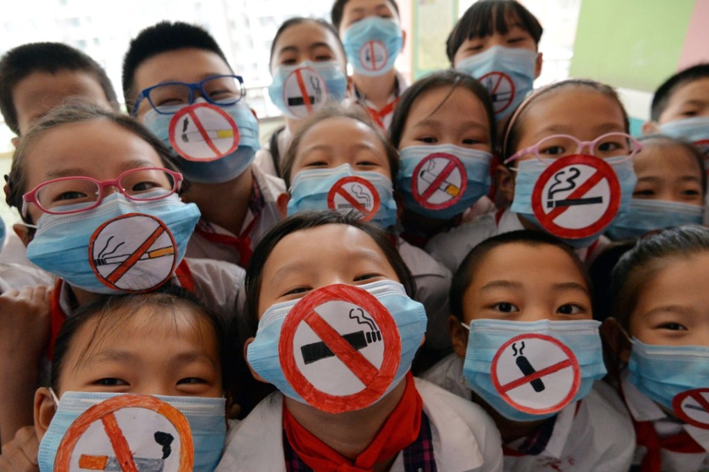 Students wear masks with “No Smoking” signs to support World No Tobacco Day last year, at a primary school in Handan, in the Hebei province of China, the world’s biggest producer and consumer of tobacco products. Photo: AFP
