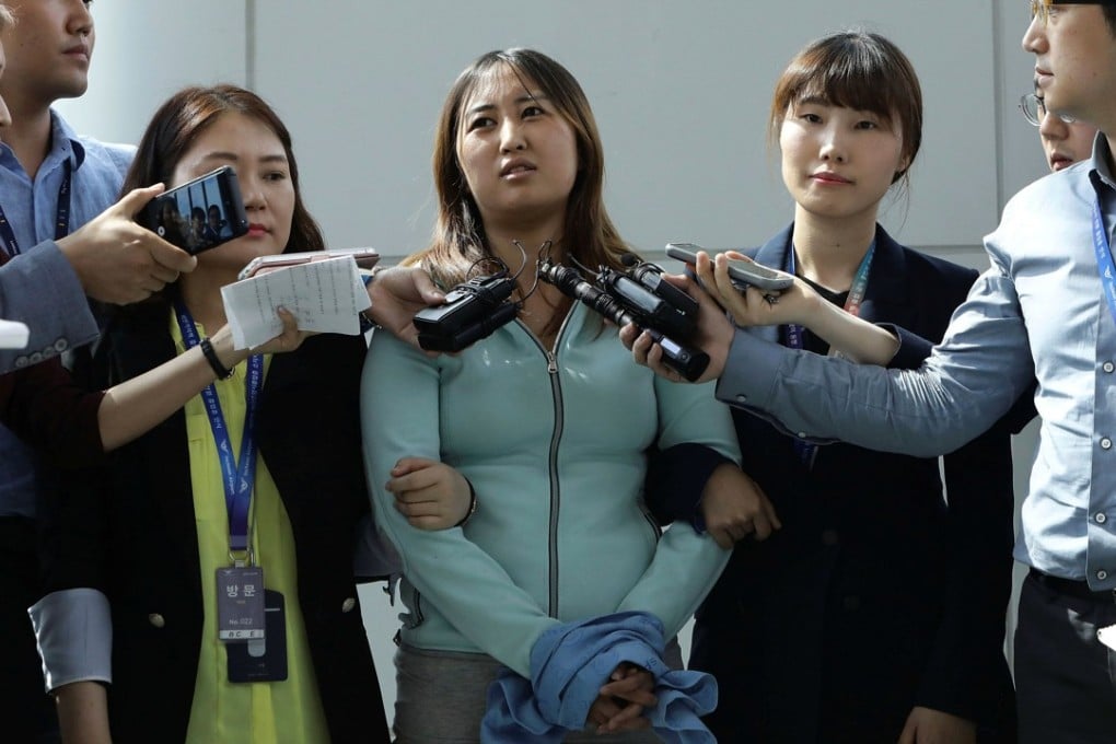 Chung Yoo-ra, the 20-year-old daughter of Choi Soon-sil, answers questions from the press after arriving at the Incheon International Airport. Photo: Reuters