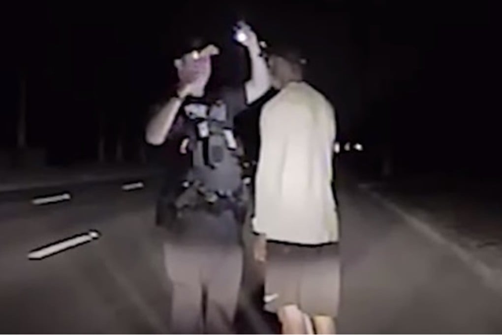 Tiger Woods is tested by a police officer during his driving under the influence arrest in still from dashcam video footage. Photo: Youtube