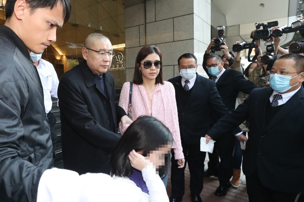 Joseph Lau Luen-hung (second from left), his wife Chan Hoi-wan and daughter leave China Evergrande Centre in Wan Chai. Photo: Edward Wong