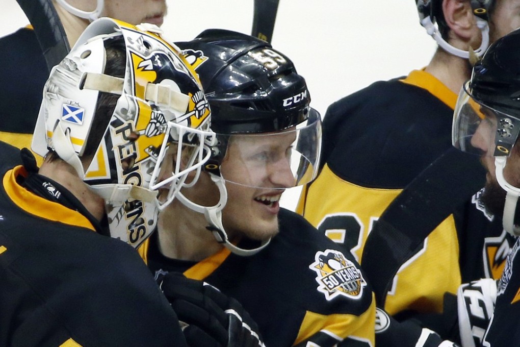 Jake Guentzel (middle) and his teammates celebrate the Penguins win over the Predators. Photo: AP