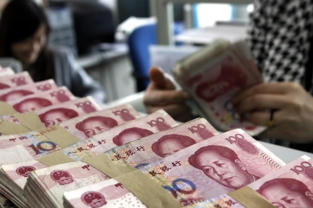 A bank clerk counts Chinese currency notes in Shenyang, Liaoning province. Photo: AP