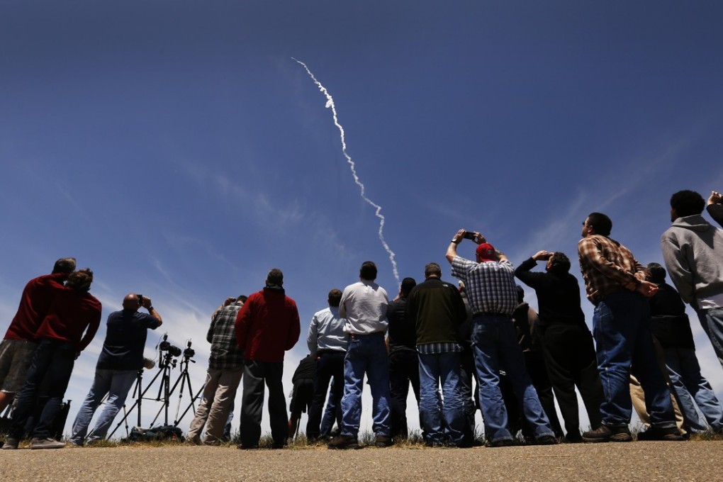 Spectators watch as a ground-based interceptor missile is launched from Vandenberg Air Force Base, California, on Tuesday. Photo: Los Angeles