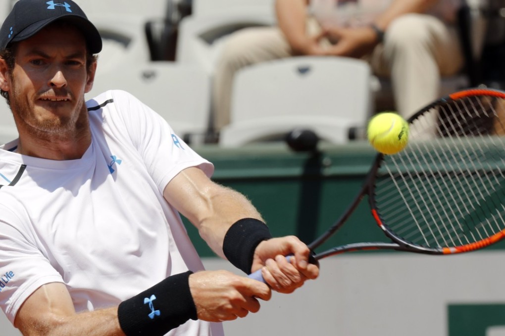 Andy Murray hits a return to Martin Klizan, of Slovakia. Photo: EPA
