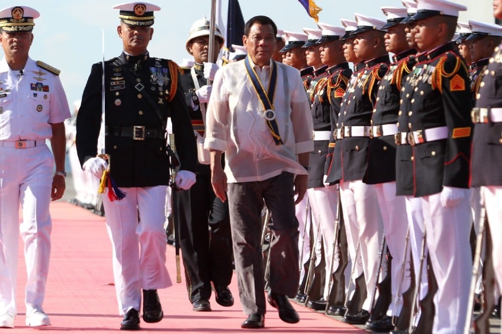 President Rodrigo Duterte inspects an honour guard as he attends celebrations for the 119th anniversary of the Philippine Navy in Davao, Mindanao, on May 31. Duterte imposed martial law in Mindanao on May 23. Photo: AFP