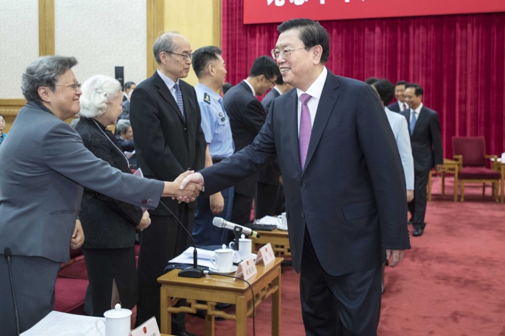 Zhang Dejiang shakes hands with Hong Kong’s Rita Fan Hsu Lai-tai, a member of the NPC Standing Committee, at a high-ranking symposium commemorating the 20th anniversary of the implementation of the Basic Law, at the Great Hall of the People in Beijing on May 27. Photo: Xinhua