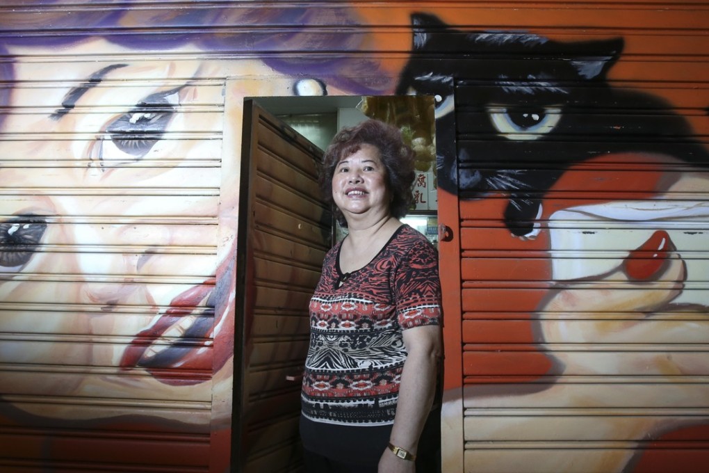 Chow Fung-king, owner of soy products store Kwan Hing Kee, inspired her shutter art with her big smile and cat. Photo: David Wong