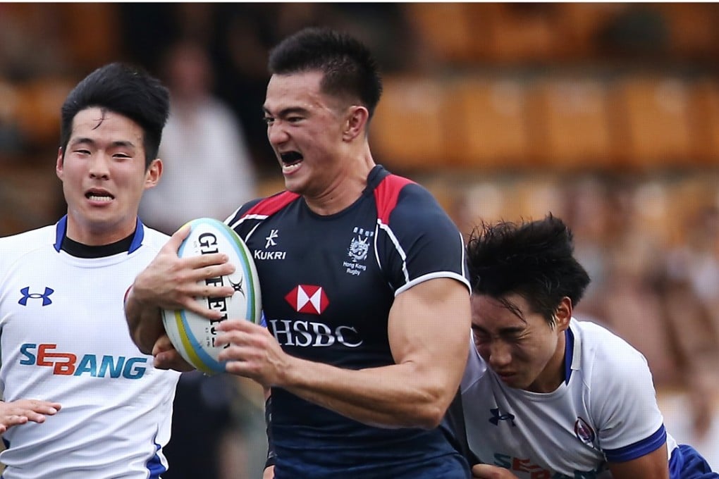 Hong Kong forward Kyle Sullivan is run down by the South Korea defence at Hong Kong Football Club on Saturday. Photo: Jonathan Wong