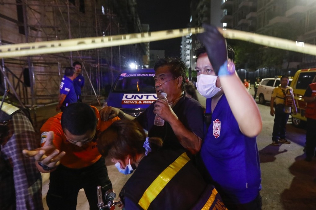 A civilian receives treatment after being evacuated from The Resorts World Manila hotel and casino complex in Pasay City. Photo: EPA