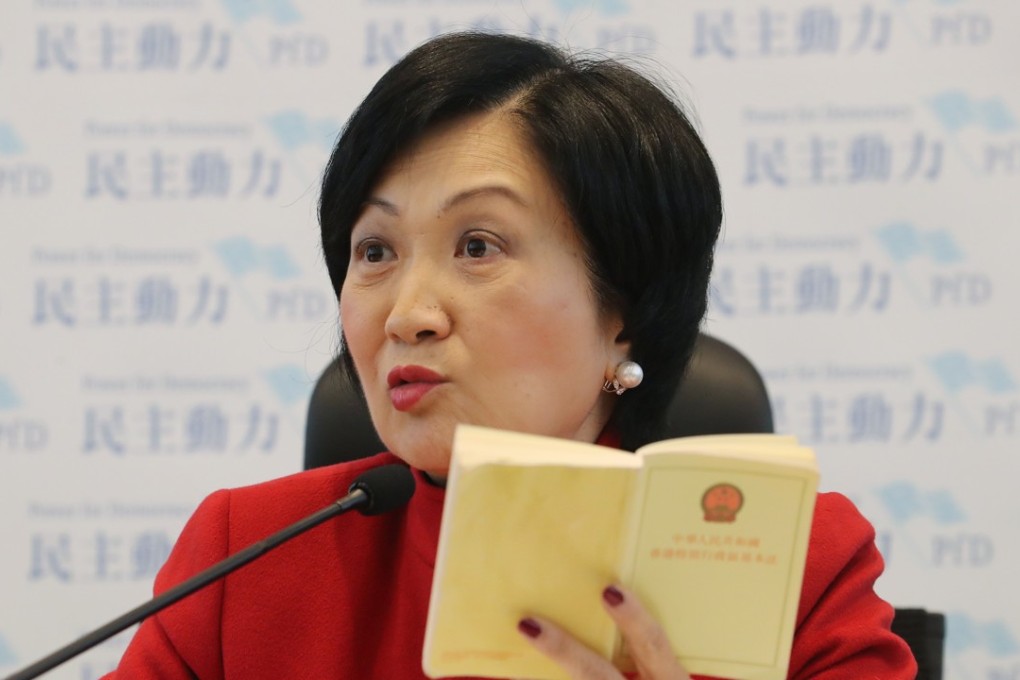 Lawmaker Regina Ip Lau Suk-yee holds up a copy of the Basic Law. Photo: Edward Wong