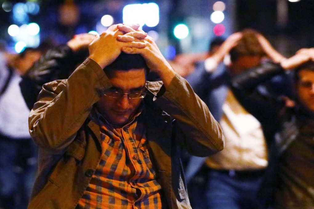 People leave the area with their hands up after an incident near London Bridge. Photo: Reuters