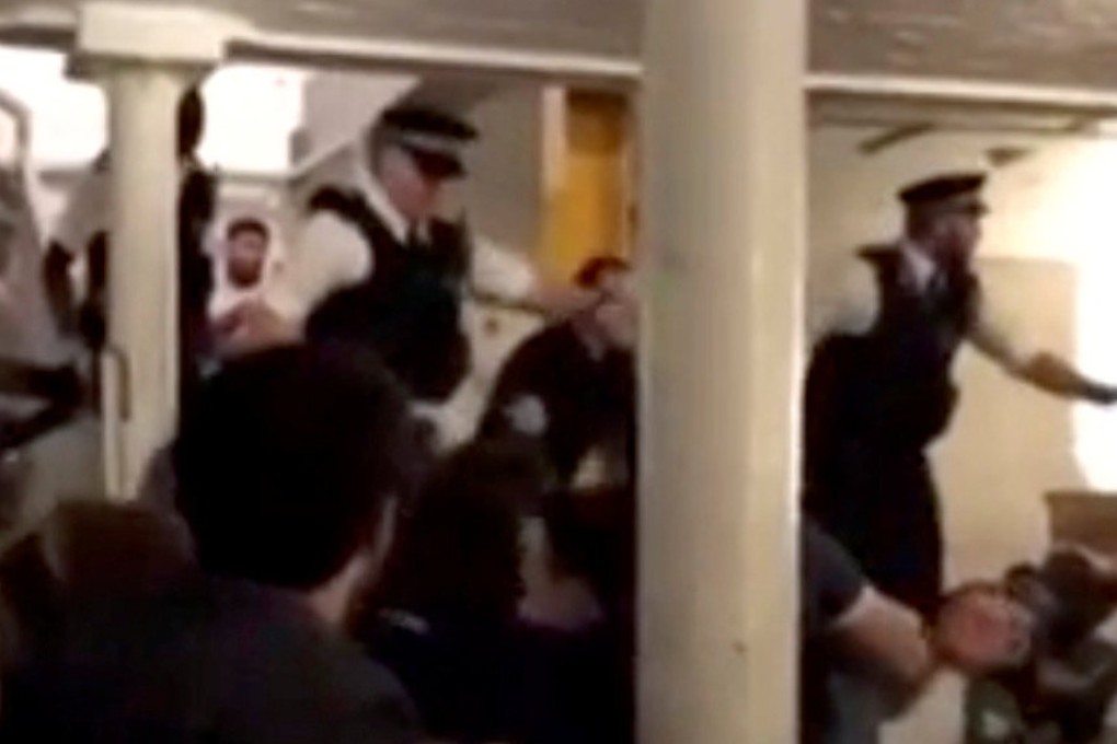 Police enter a bar in London, telling people to get down. Photo: Twitter