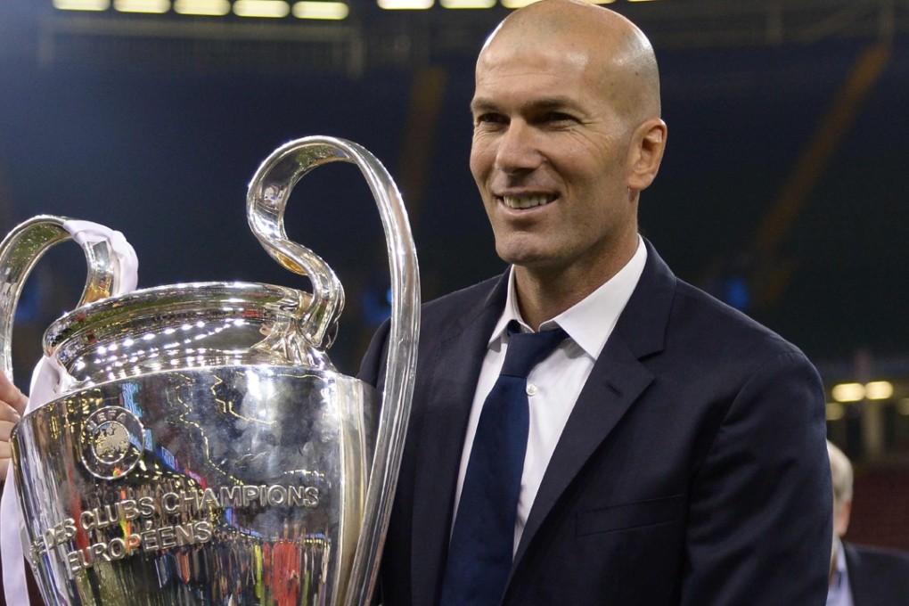 Real Madrid's French coach Zinedine Zidane lifts the trophy. Photo: AFP