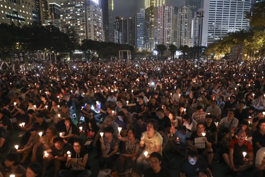 Candles aloft at Victoria Park. Photo: Robert Ng