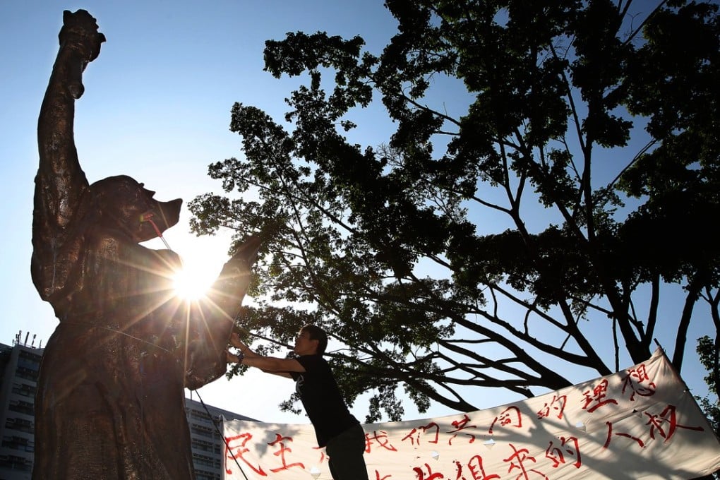 A student cleans and decorates a statue of the ‘Goddess of Democracy’ in 2012 in commemoration of the June 4 crackdown. Photo: Sam Tsang