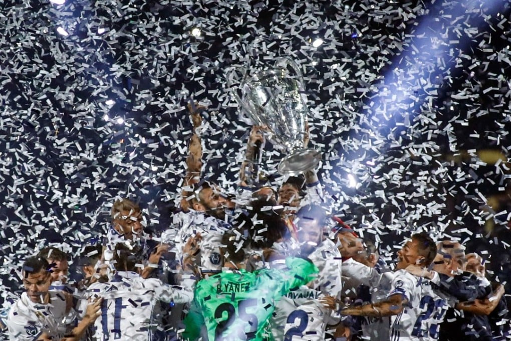 Real Madrid players celebrate with the trophy under confetti during a celebration event held at the Santiago Bernabeu stadium after their Uefa Champions League win. Photo: AFP