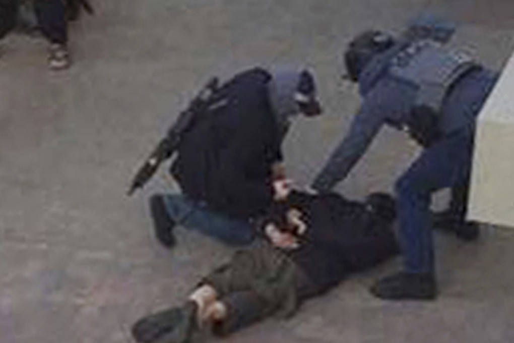 A person, on ground, being detained by police at Elizabeth Fry apartments in Barking, east London. Photo: AP
