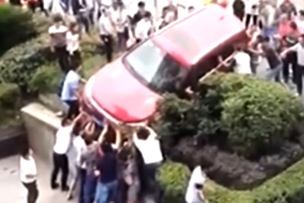 Passers-by working to free the trapped man. Photo: Handout