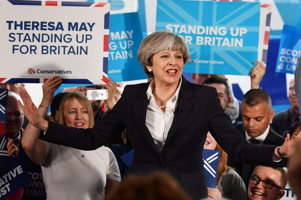 British Prime Minister Theresa May speaks during a general election campaign visit to a removals depot in Edinburgh, Scotland, on June 5, 2017. Britain goes to the polls on June 8 to vote in a general election only days after another terrorist attack on the nation's capital. / AFP PHOTO / POOL AND AFP PHOTO / BEN STANSALL
