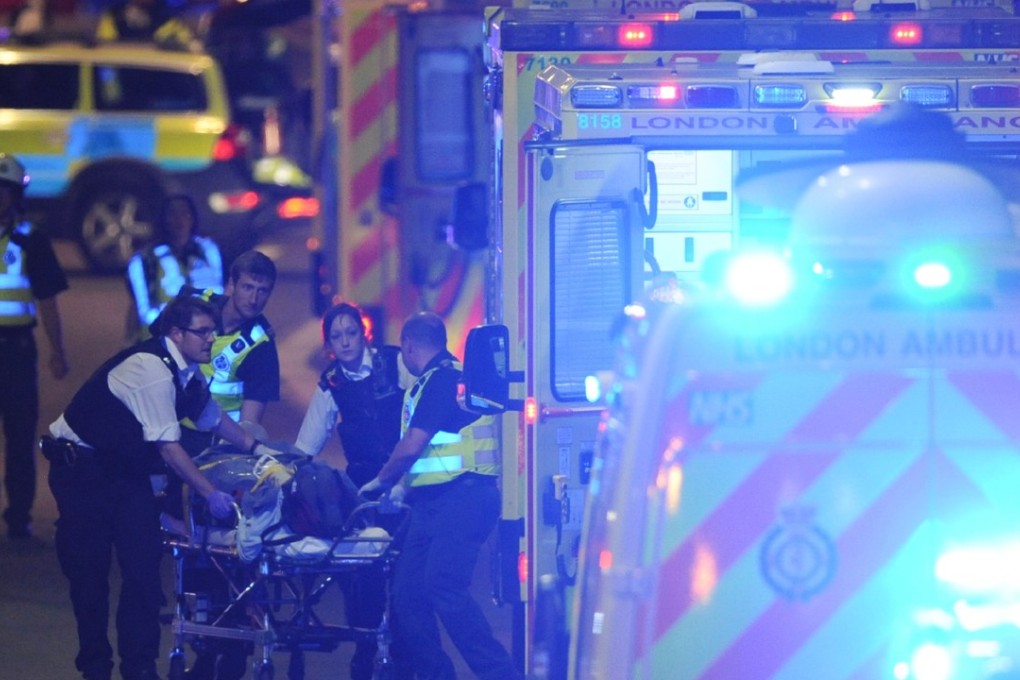 Members of the emergency services attend to a person injured in the terror attack in London on Saturday. Photo: AFP