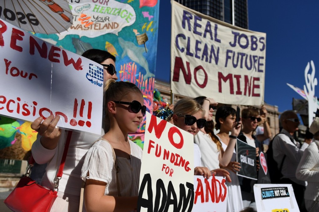 epaselect epa05987992 Environmental activists voice their opposition to Indian miner Adani's proposed Carmichael coal mine, outside Parliament House in Brisbane, Queensland, Australia, 25 May 2017. The protesters called on the Queensland government to block a billion-dollar federal loan to Adani. EPA/DAN PELED AUSTRALIA AND NEW ZEALAND OUT