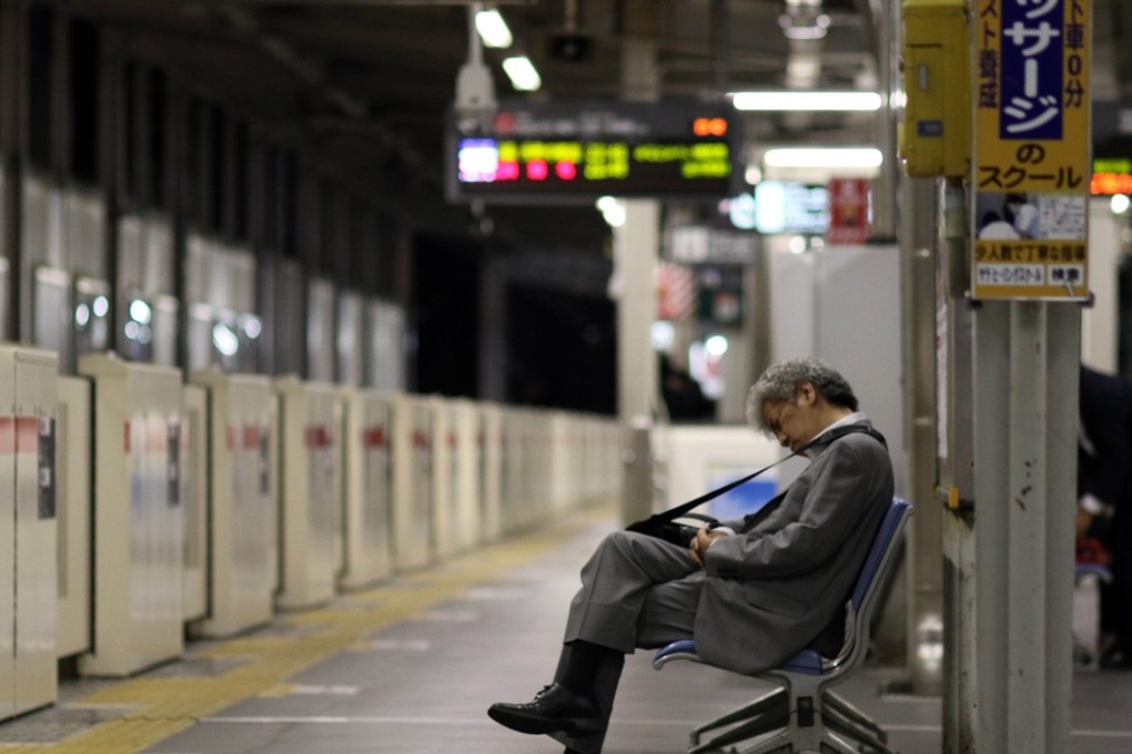 Facing uncertain economic times and growing competition, Japanese companies are demanding more from their staff. File photo: AFP