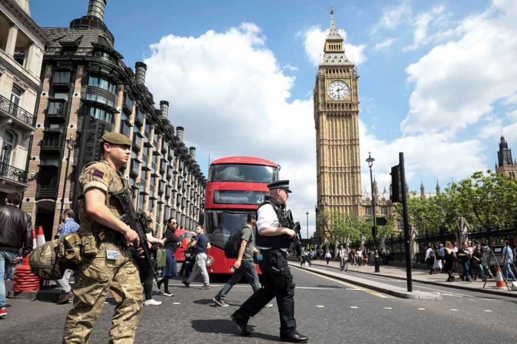 A soldier and an armed police officer patrol near the Elizabeth Tower, also known as Big Ben, in London on May 24. Photo: Bloomberg