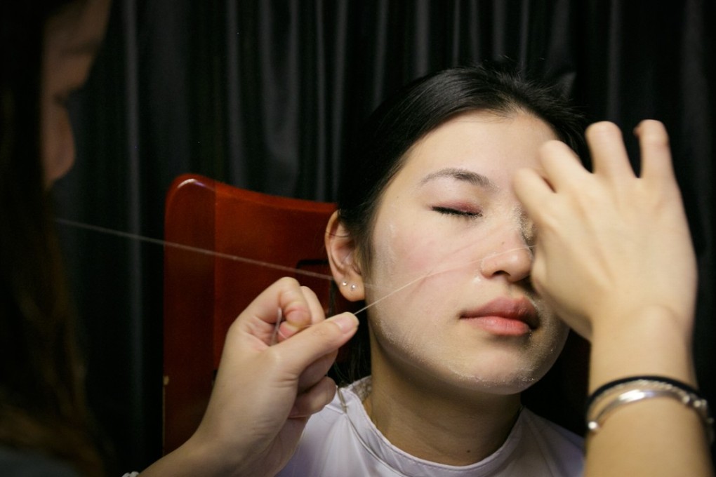 Moona Kwok, 24, inherited the face threading business from her mother, but knows of few other people her age practising it. Photo: Tessa Chan