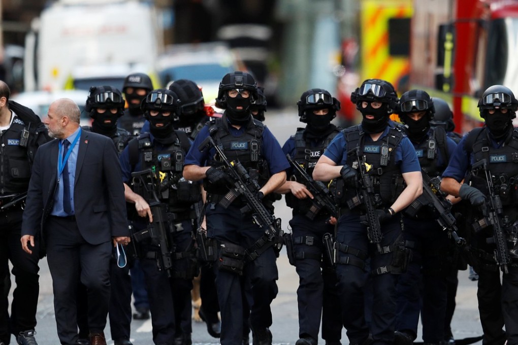 Armed police officers walk outside Borough Market after an attack left seven people dead and dozens injured in London. Photo: Reuters