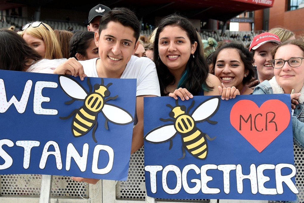 Fans pose ahead of the One Love Manchester benefit concert for the victims of the Manchester Arena terror attack at Emirates Old Trafford. Photo: Reuters