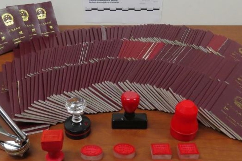 An array of Chinese passports that were endorsed with fake and doctored stamps by Canadian immigration consultant Xun Wang. Wang's tactics helped rich migrants maintain the illusion of their presence in Canada when they were actually living and working in China. Photo: CBSA