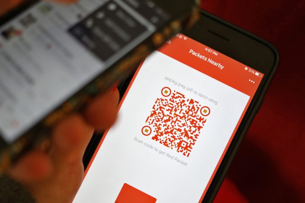 A WeChat user scanning a QR code on a smartphone. Photo: EPA