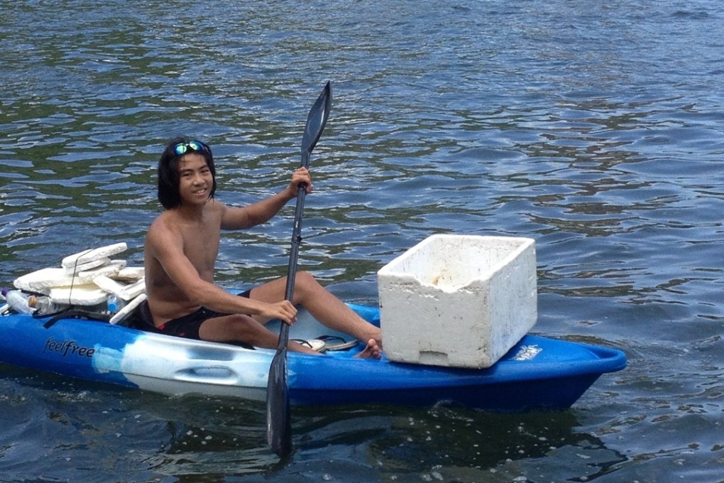 A young paddler collects plastic in Repulse Bay in an attempt to curb the pollution problem. Photo: Ocean Recovery Alliance