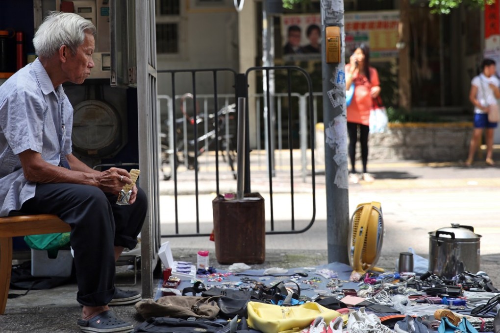 An elderly man sells secondhand goods on a street in Hong Kong’s Sham Shui Po district. Photo: Sam Tsang